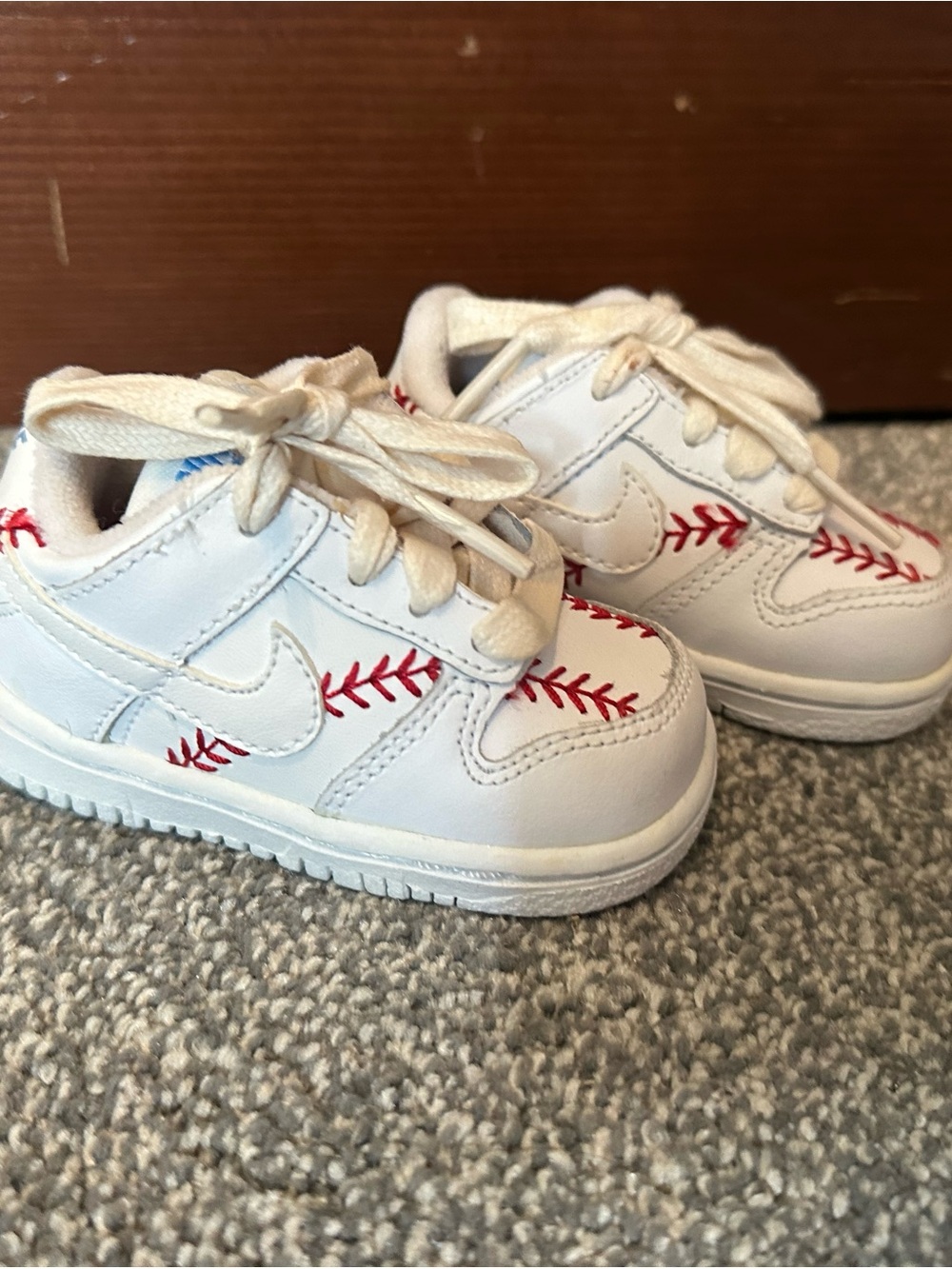 Nike White Baby Sneakers with Red Baseball Stitching